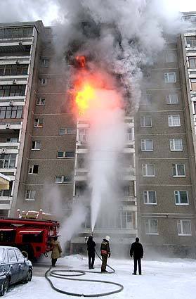 Firefighters try to extinguish the fire at an appartment building in Yekaterinburg, about 900 miles east of Moscow on Tuesday. People try to use electric heating devices in addition to central heating systems, which frequently causes accidental fires.