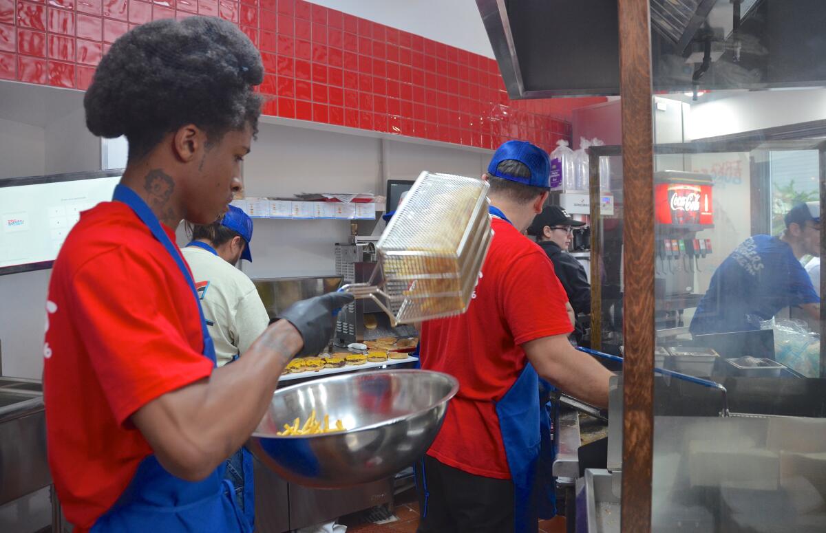 Cooks prepare burgers and fries to serve to hungry patrons at Irv's Burgers.