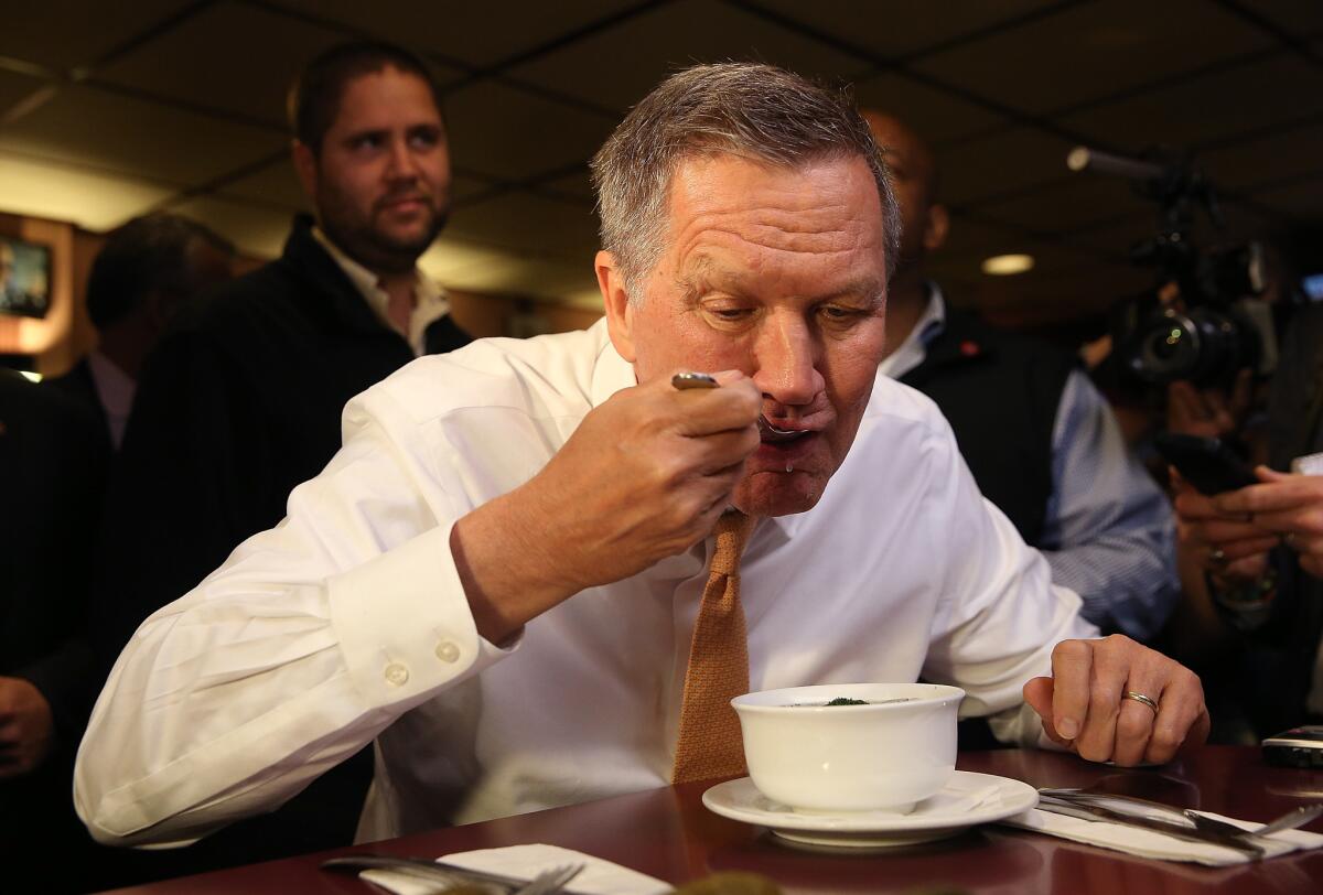 Republican presidential candidate John Kasich eats soup at PJ Bernstein's Deli Restaurant on Saturday in New York.