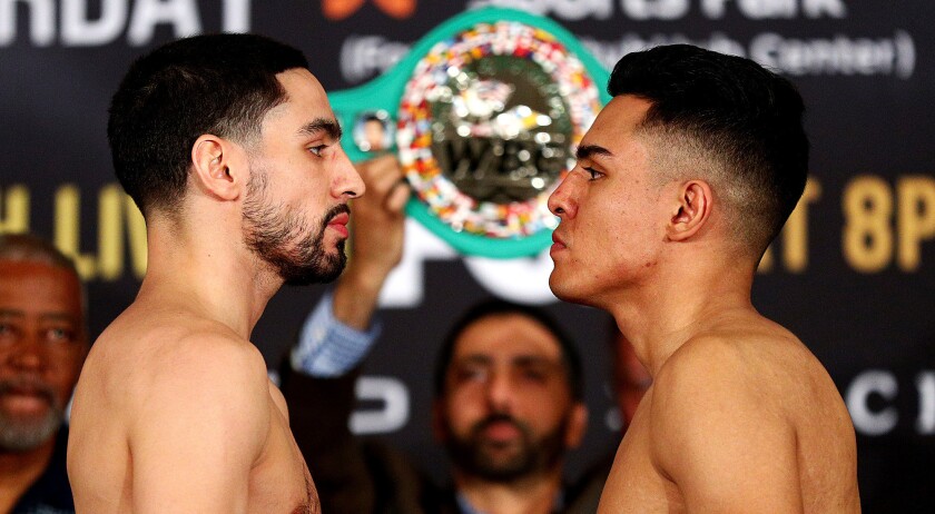Danny Garcia, left, and Adrian Granados stare each other down during their official weigh-in Friday.