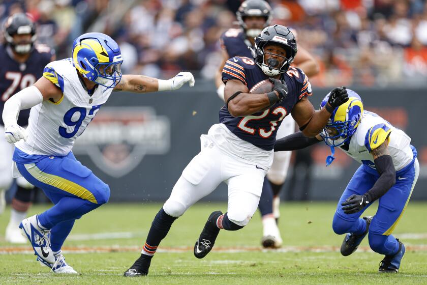 The Bears' Roschon Johnson (23) runs through the Rams secondary in Week 4.