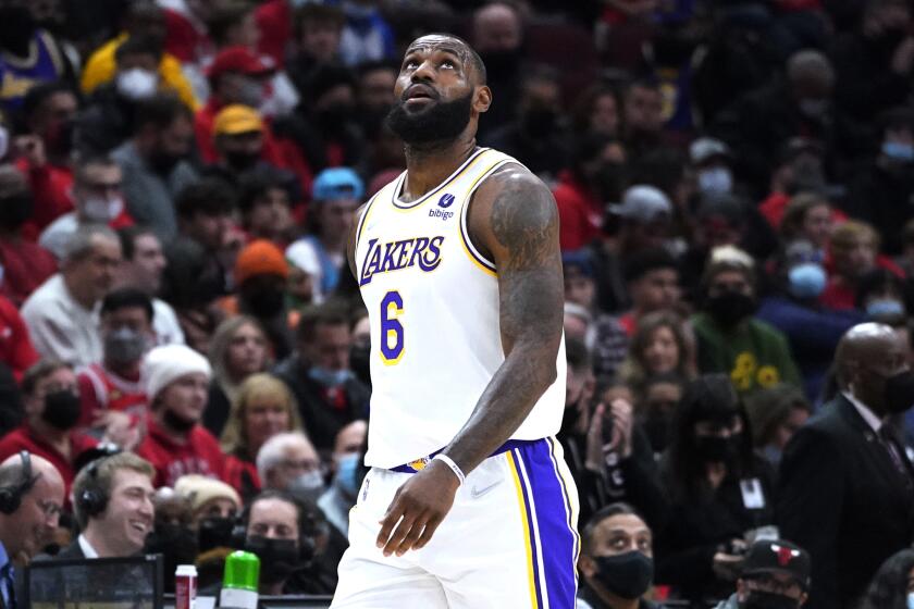 Los Angeles Lakers forward LeBron James looks up the scoreboard as he walks to the bench