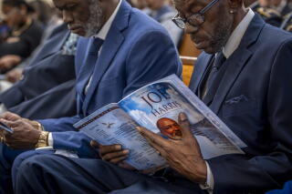 An attendee holds onto a program commemorating Joe Harris.