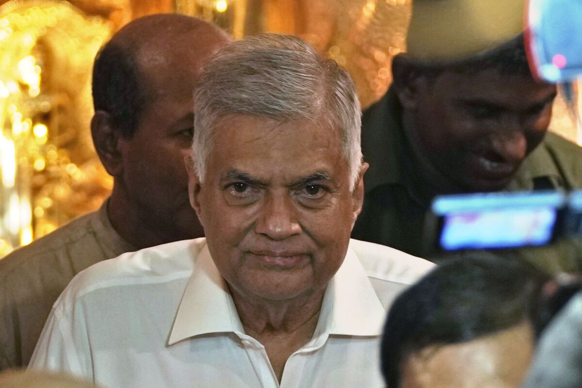 Sri Lanka's new prime minister Ranil Wickremesinghe arrives at a Buddhist temple in Colombo, Sri Lanka, Thursday, May 12, 2022. Five-time former Sri Lankan Prime Minister Ranil Wickremesinghe was reappointed Thursday in an effort to bring stability to the island nation, engulfed in a political and economic crisis.(AP Photo/Eranga Jayawardena)