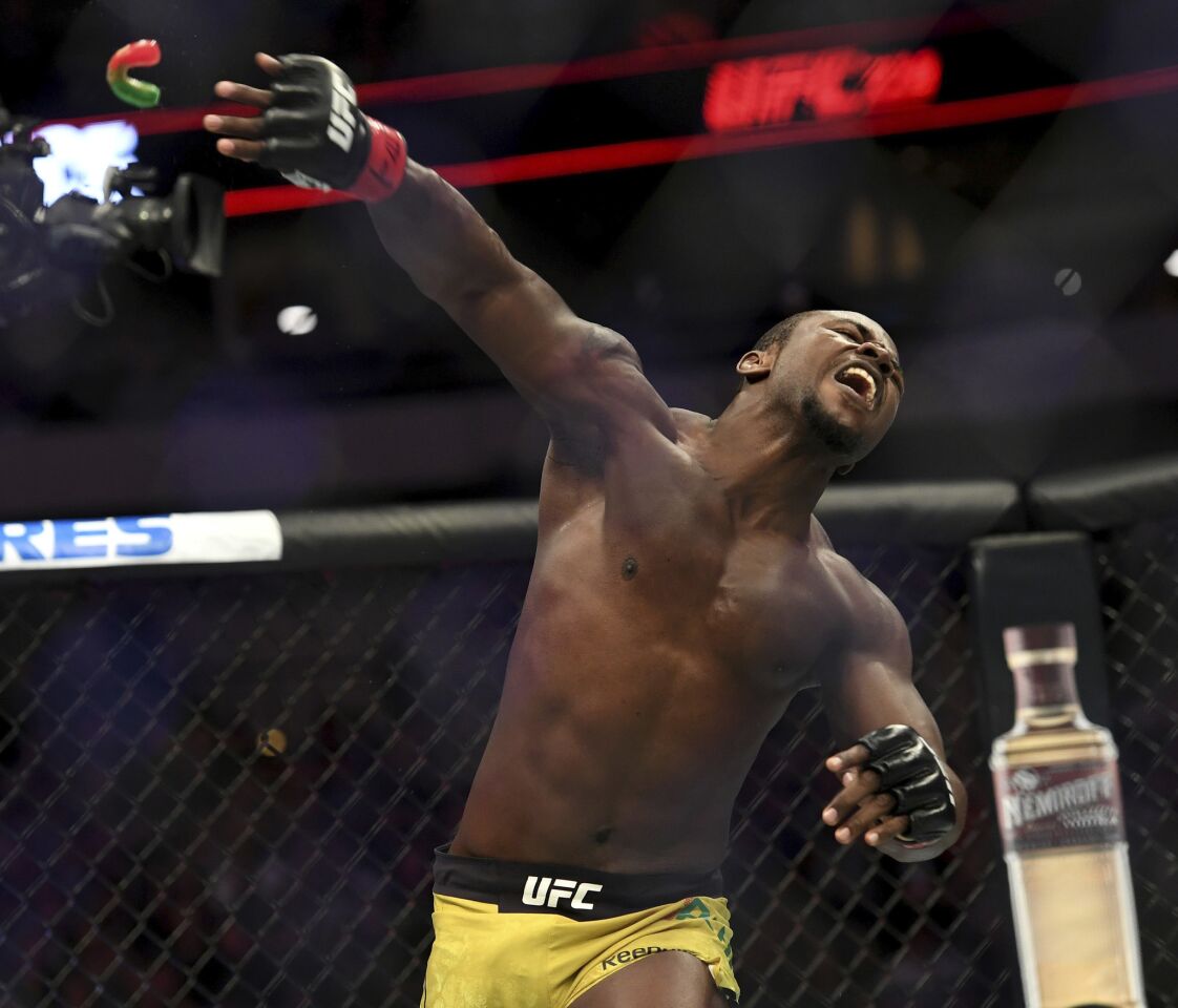 Abdul Razak Alhassan throws his mouthpiece in celebration after knocking out Niko Price in their welterweight mixed martial arts bout at UFC 228 on Saturday, Sept. 8, 2018, in Dallas. (AP Photo/Jeffrey McWhorter)