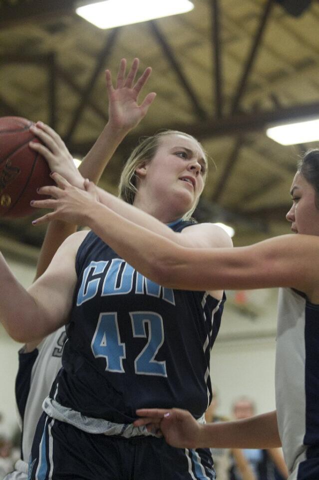 Corona del Mar High's Krista Anderson battles for a rebound with Newport Harbor's Jennifer Lopez during a game on Tuesday.