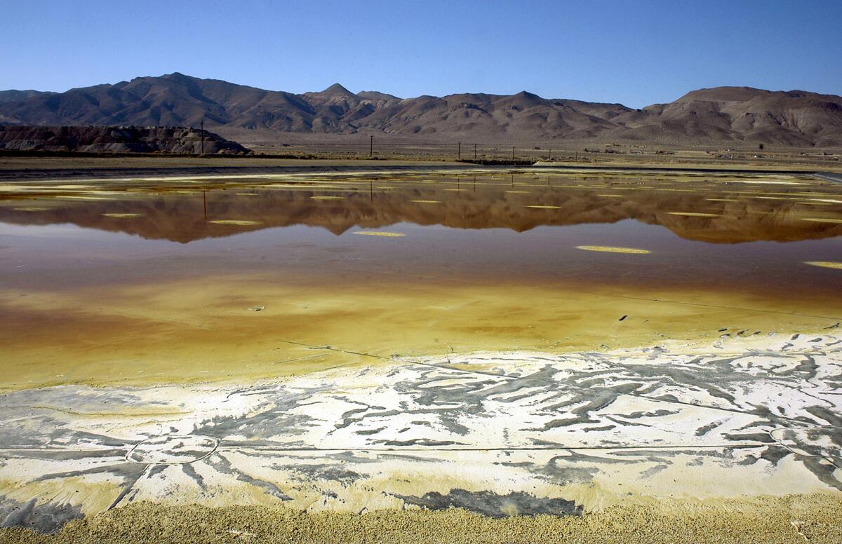 In this Nov. 30, 2004, file photo, an evaporation pond holds contaminated fluid and sediment at the former Anaconda copper mine near Yerington, Nev. The Environmental Protection Agency wants to add the abandoned site to its Superfund National Priority List.