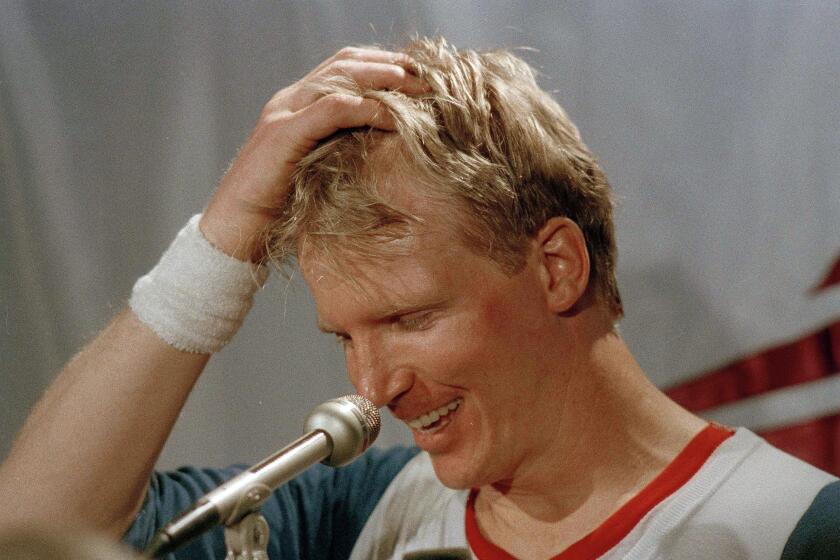 New York Giants quarterback Phil Simms (11) smiles as he talks about the Giants 39-20 victory over the Denver Broncos in Super Bowl XXI in Pasadena, Jan. 26, 1987. (AP Photo/Lennox McLendon)