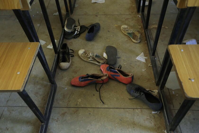 FILE - Shoes of the kidnapped students from Government Science Secondary School are seen inside their class room Kankara, Nigeria, Wednesday, Dec. 16, 2020. Rebels from the Boko Haram extremist group claimed responsibility. The new global epicenter of violent Islamic extremism is sub-Saharan Africa where people are increasingly joining because of economic factors and less by religious ones, according to a new report by the U.N.'s international development agency. (AP Photo/Sunday Alamba, File)