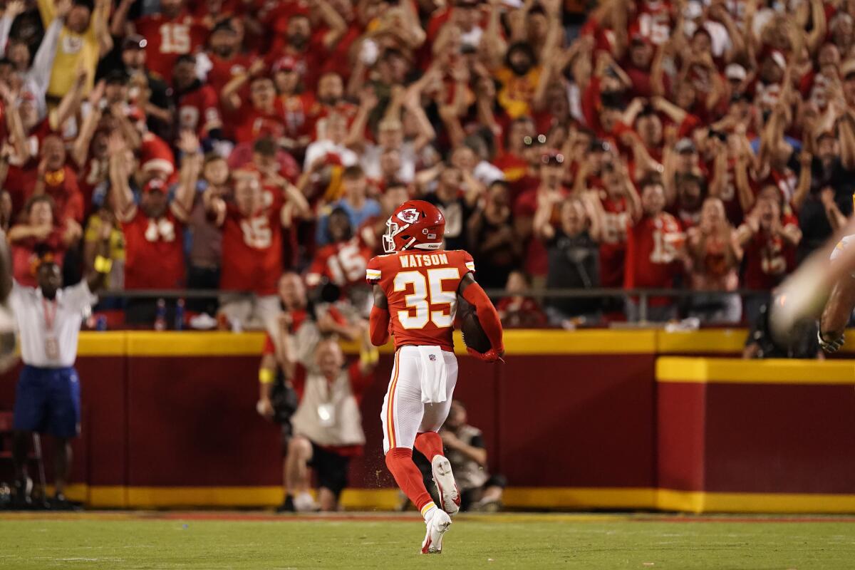 Kansas City Chiefs cornerback Jaylen Watson runs an interception back for a touchdown during the second half of an NFL football game against the Los Angeles Chargers Thursday, Sept. 15, 2022, in Kansas City, Mo. (AP Photo/Charlie Riedel)