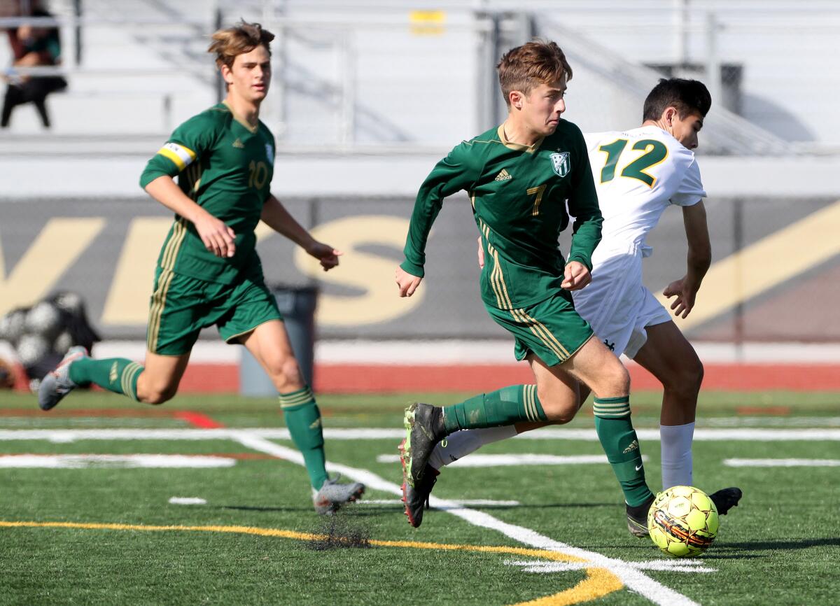 Edison's Armand Pigeon (7) looks to pass in a match against Mira Costa at Laguna Hills High on Dec. 28, 2019.
