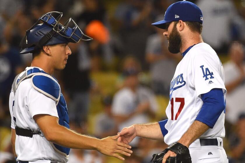 LOS ANGELES, CA. - JUNE 27: Austin Barnes #15 of the Los Angeles Dodgers shakes hands with Brandon Morrow #17 of the Los Angeles Dodgers after earning a save in the ninth inning of the game against the Los Angeles Angels of Anaheim at Dodger Stadium on June 27, 2017 in Los Angeles, California. (Photo by Jayne Kamin-Oncea/Getty Images) ** OUTS - ELSENT, FPG, CM - OUTS * NM, PH, VA if sourced by CT, LA or MoD **