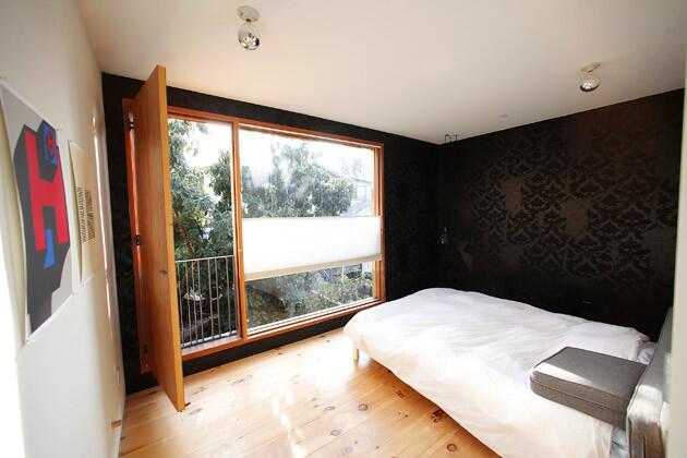Storey also designed the bedroom wallpaper, his take on vintage brocade.