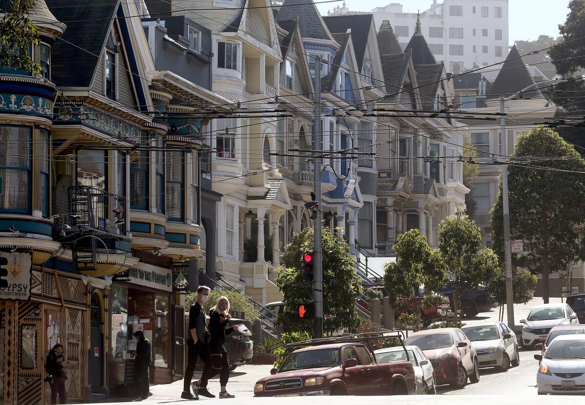 Pedestrians wear masks as they walk along Haight Street in San Francisco in October.