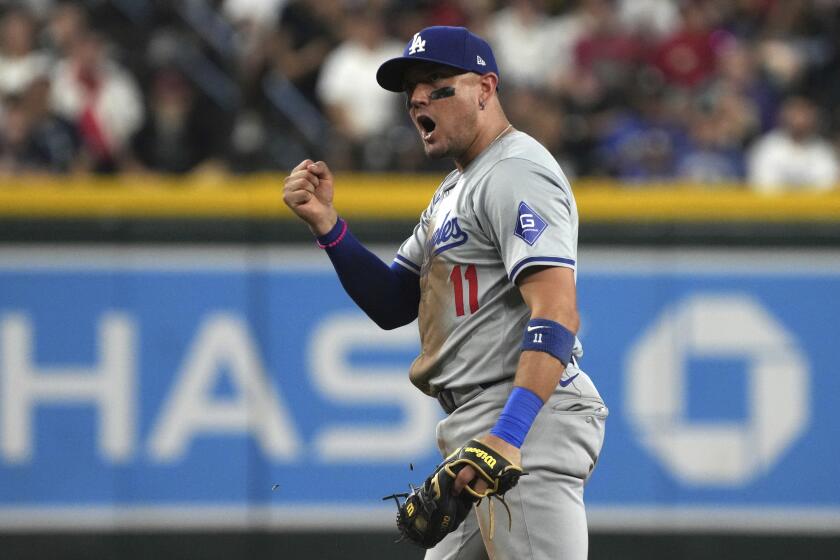 Los Angeles Dodgers shortstop Miguel Rojas reacts after tagging out Arizona Diamondbacks.