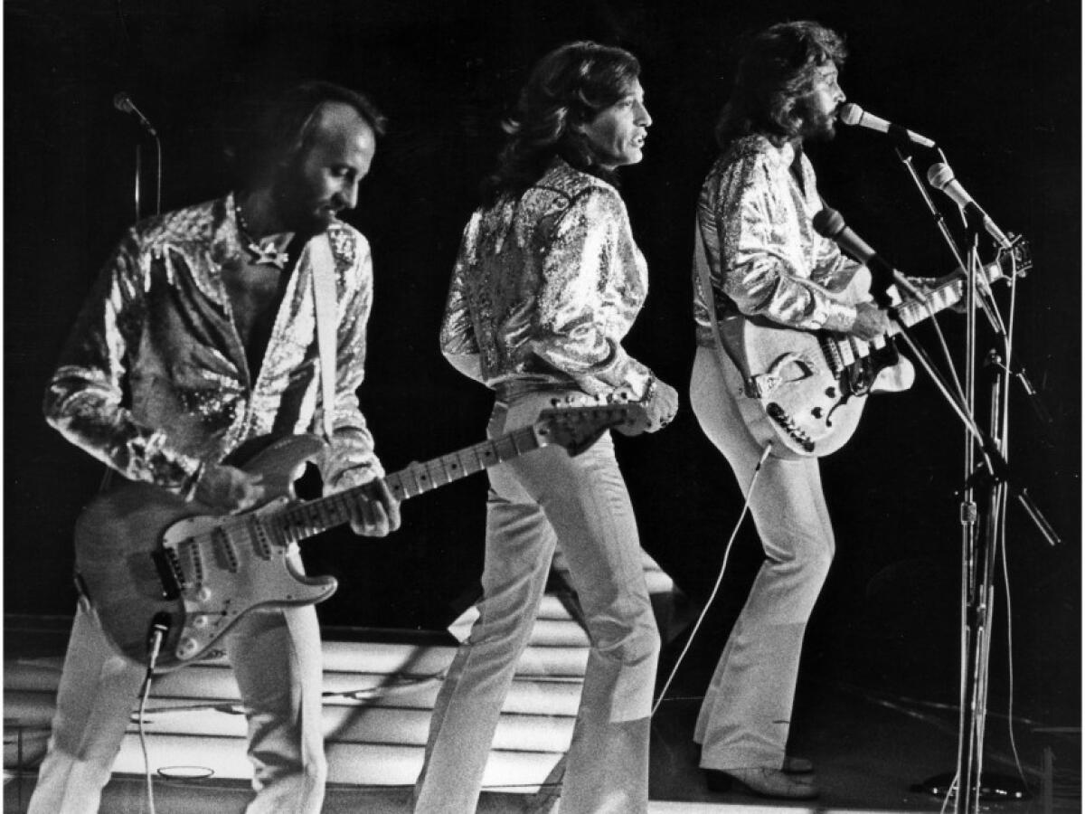 July 7, 1979: The Bee Gees perform at Dodger Stadium. From left are Maurice, Robin and Barry Gibb.