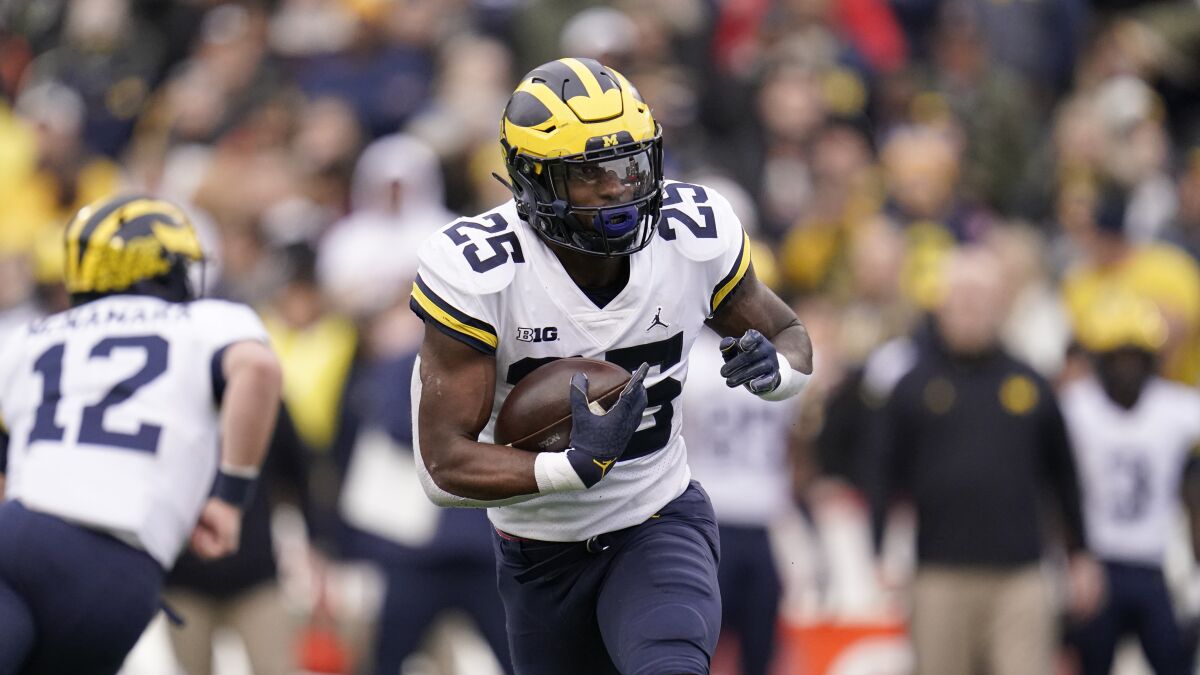 Michigan running back Hassan Haskins runs with the ball against Maryland.