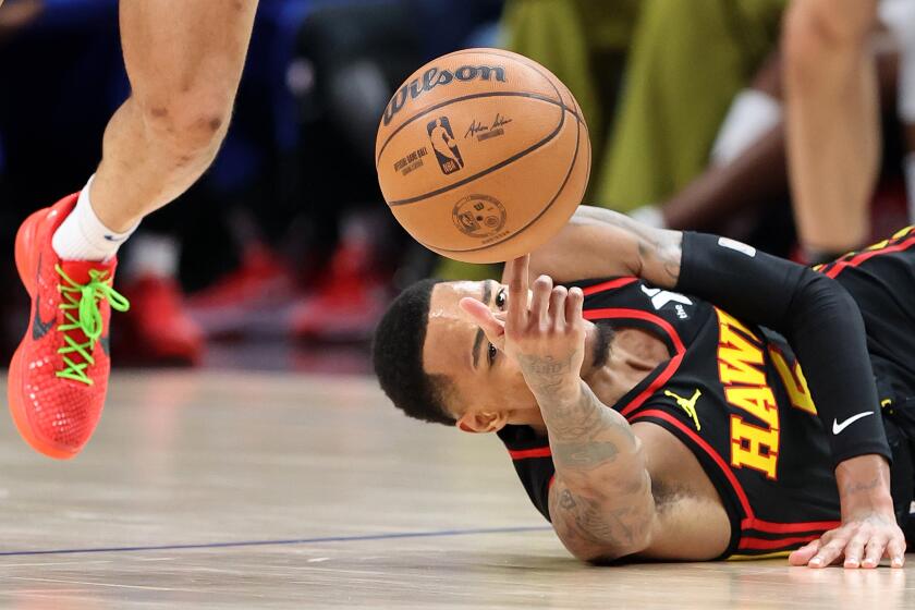 Los Angeles, California March 17, 2024-Hawks Dejounte Murray is knocked down by a Clippers player in the second half at Crypto.com Arena Sunday. (Wally Skalij/Los Angeles Times)