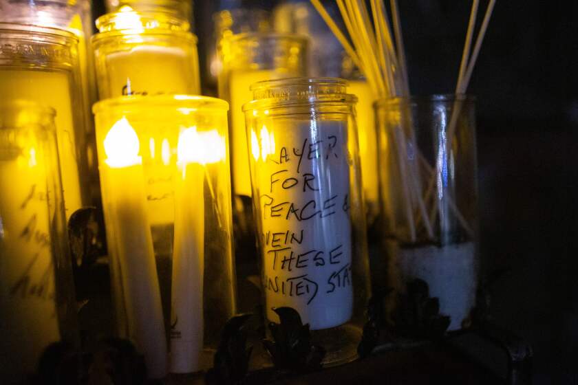 Candles with messages written are pictured during a "Unity Vigil" ahead of the 59th inaugural ceremony for President-elect Joe Biden and Vice President-elect Kamala Harris, at Cathedral Church of St. John the Divine in New York on January 19, 2021. (Photo by Kena Betancur / AFP) (Photo by KENA BETANCUR/AFP via Getty Images)