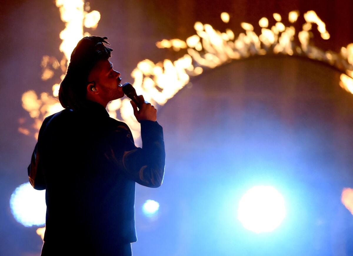 The Weeknd performs during the 2015 American Music Awards at Microsoft Theater in Los Angeles.