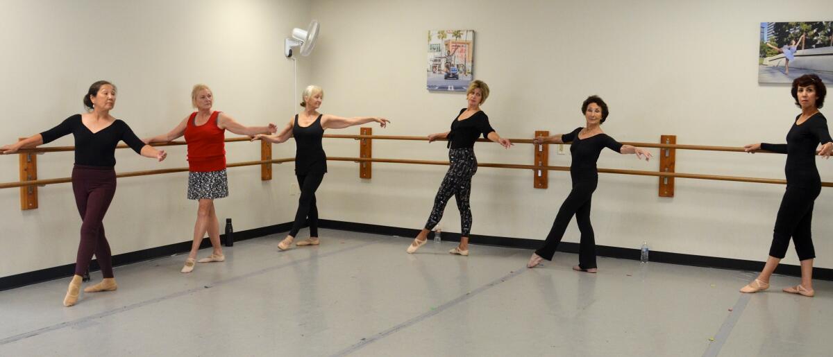 Miss Pepa Dodge takes her 55-and-older class through ballet poses.