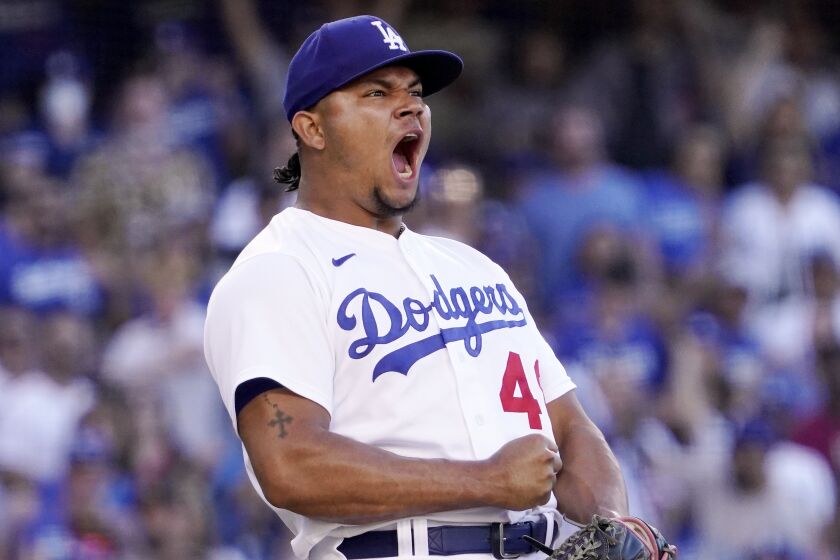 Los Angeles Dodgers relief pitcher Brusdar Graterol celebrates after striking out San Diego Padres' Manny Machado.