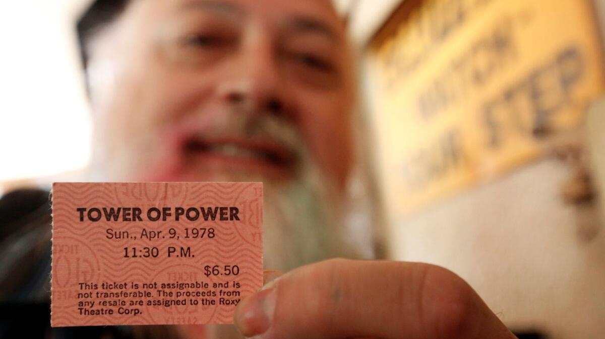 Richard Vasquez, 57, displays a ticket for a Tower of Power show at the Roxy from 1978 during a memorial for late-night club owner Mario Maglieri at the Rainbow Bar & Grill in West Hollywood on Sunday.