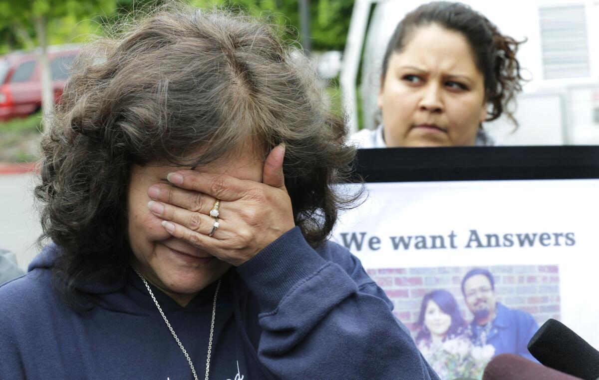 Marilyn Covarrubias, left, talks with reporters on May 11, 2015, outside police headquarters in Lakewood, Wash. The interim police chief says officers shot and killed her son Daniel in a lumber yard last month because he pointed a cellphone at them as though it were a gun. At right is Lanna Covarrubias, Daniel's sister.