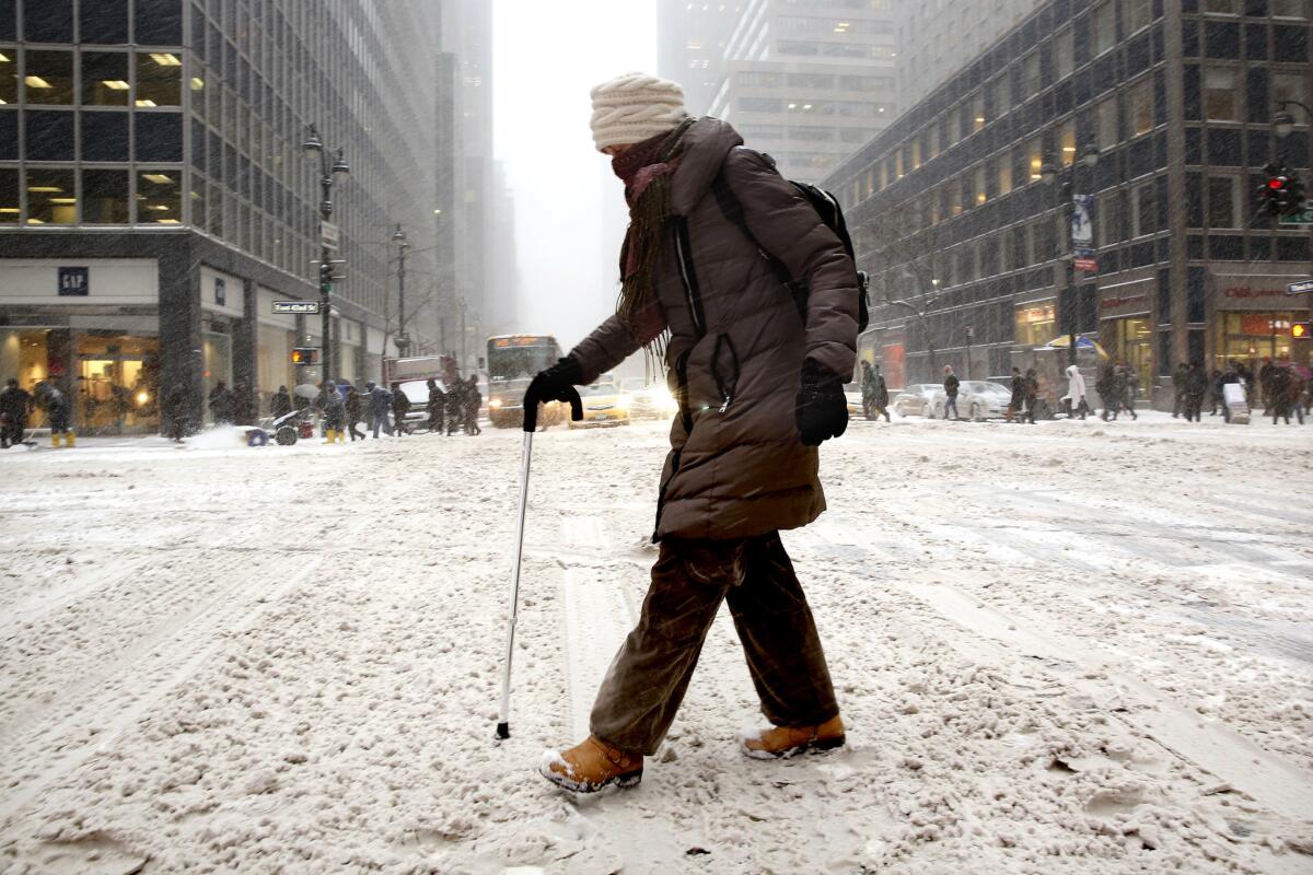 As a major winter storm pummels New York on Dec. 4, Laura Jackson makes her way across 3rd Avenue and 42nd Street on the way to a rehabilitaion appointment after having knee surgery.
