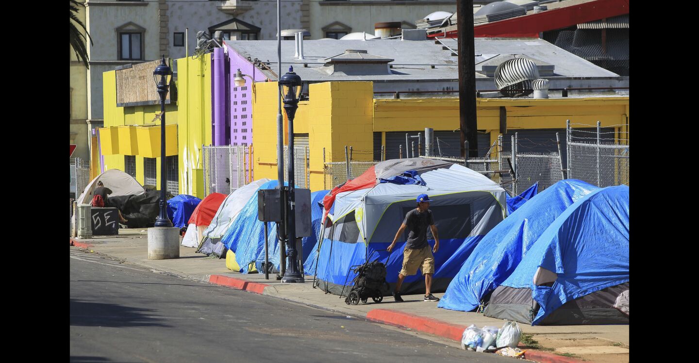 Homeless people live in tents on 17th Street in San Diego.