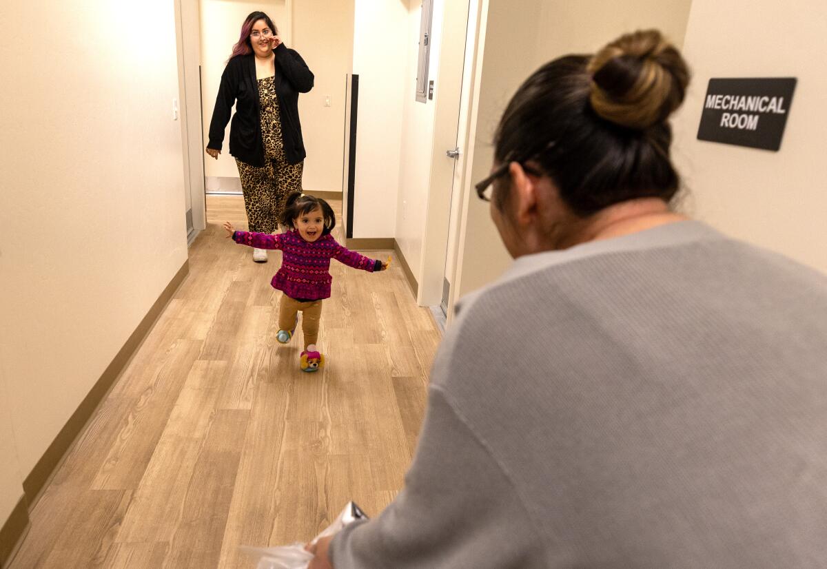 A joyful child runs through a freshly painted hallway. 