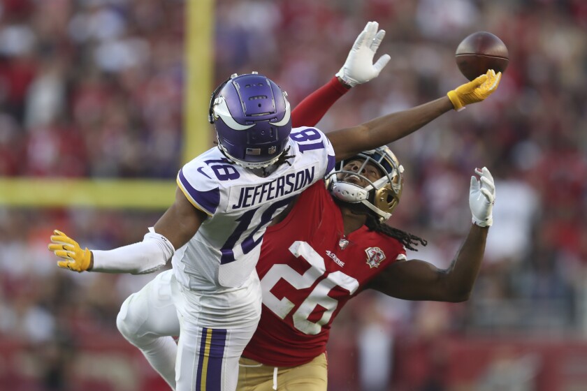 San Francisco 49ers cornerback Josh Norman (26) is called for pass interference while defending Minnesota Vikings wide receiver Justin Jefferson (18) during the second half of an NFL football game in Santa Clara, Calif., Sunday, Nov. 28, 2021. (AP Photo/Jed Jacobsohn)