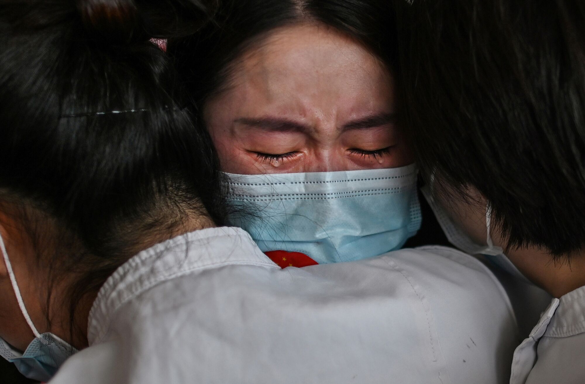 Medical staff  Jilin Province hug nurses from Wuhan after working together during coronavirus outbreak during a ceremony.