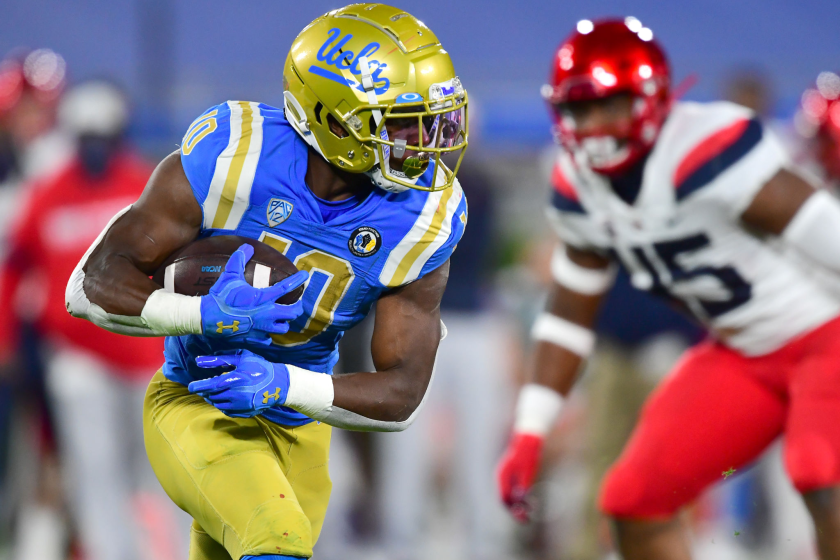 UCLA running back Demetric Felton carries the ball for a gain in the first half against Arizona on Nov. 28, 2020.