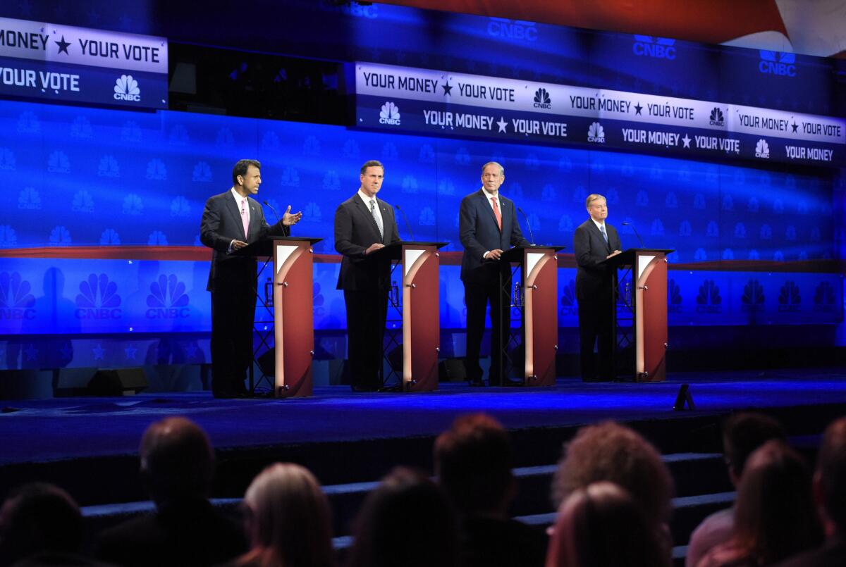 Republican presidential candidates, from left, Louisiana Gov. Bobby Jindal, former Sen. Rick Santorum of Pennsylvania, former New York Gov. George Pataki and South Carolina Sen. Lindsey Graham take the stage during the second-tier Republican presidential debate Wednesday in Boulder, Colo.