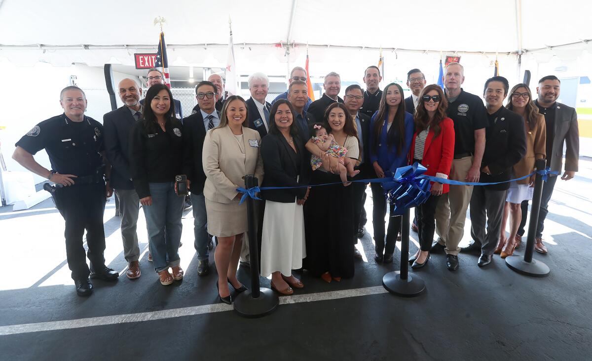 Local mayors, city officials, andO.C. supervisors stand at a ribbon-cutting in Garden Grove.