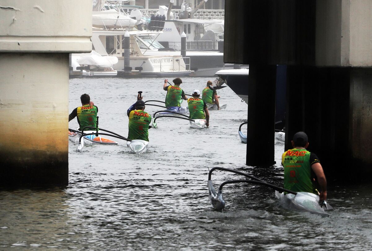 Paddlers enter Newport's marina.