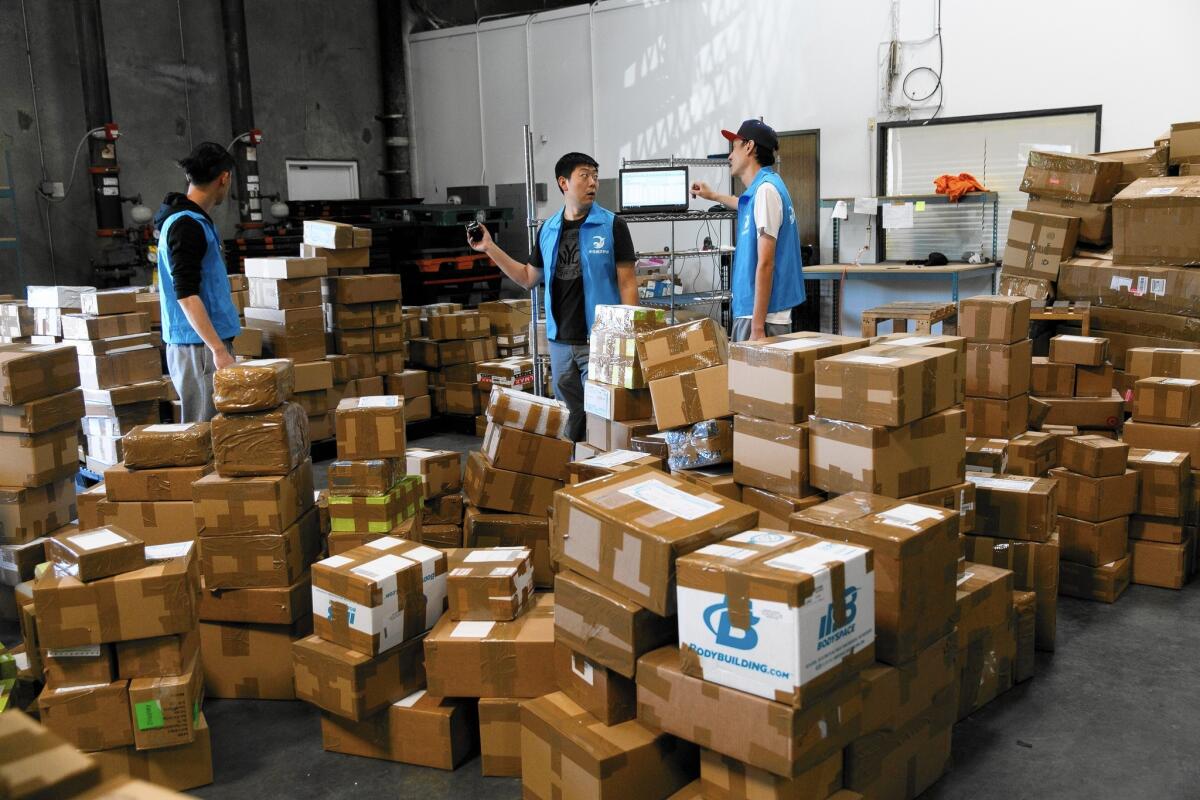Workers from Express to China, a ship-to-China company, sort through inventory at a warehouse in the City of Industry.