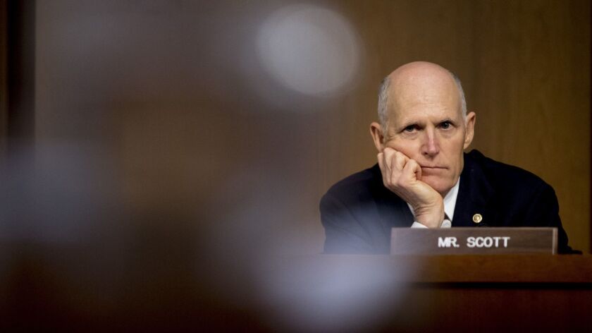 Not exactly a man of the people: Sen. Rick Scott (R-Fla.) listens to testimony at a committee hearing in Washington this week.