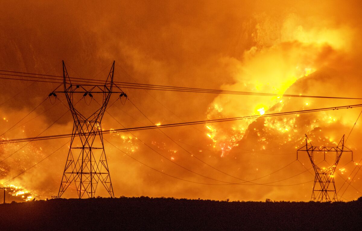 a wildfire approaching power lines