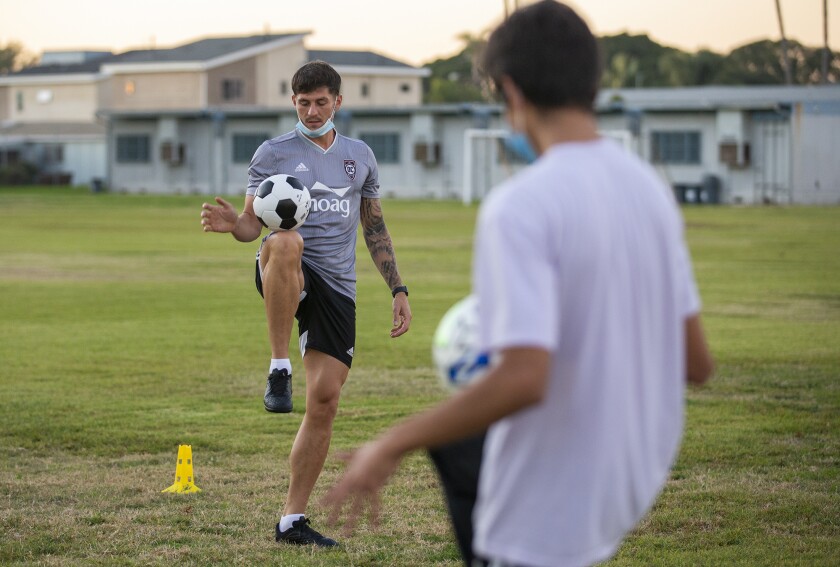 Rob Kiernan, a defender with the Orange County Soccer Club, gives instructions to youngsters during a clinic.