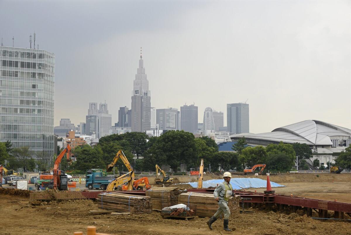 Heavy machinery sits last summer at the planned construction site of the Tokyo Olympics stadium.