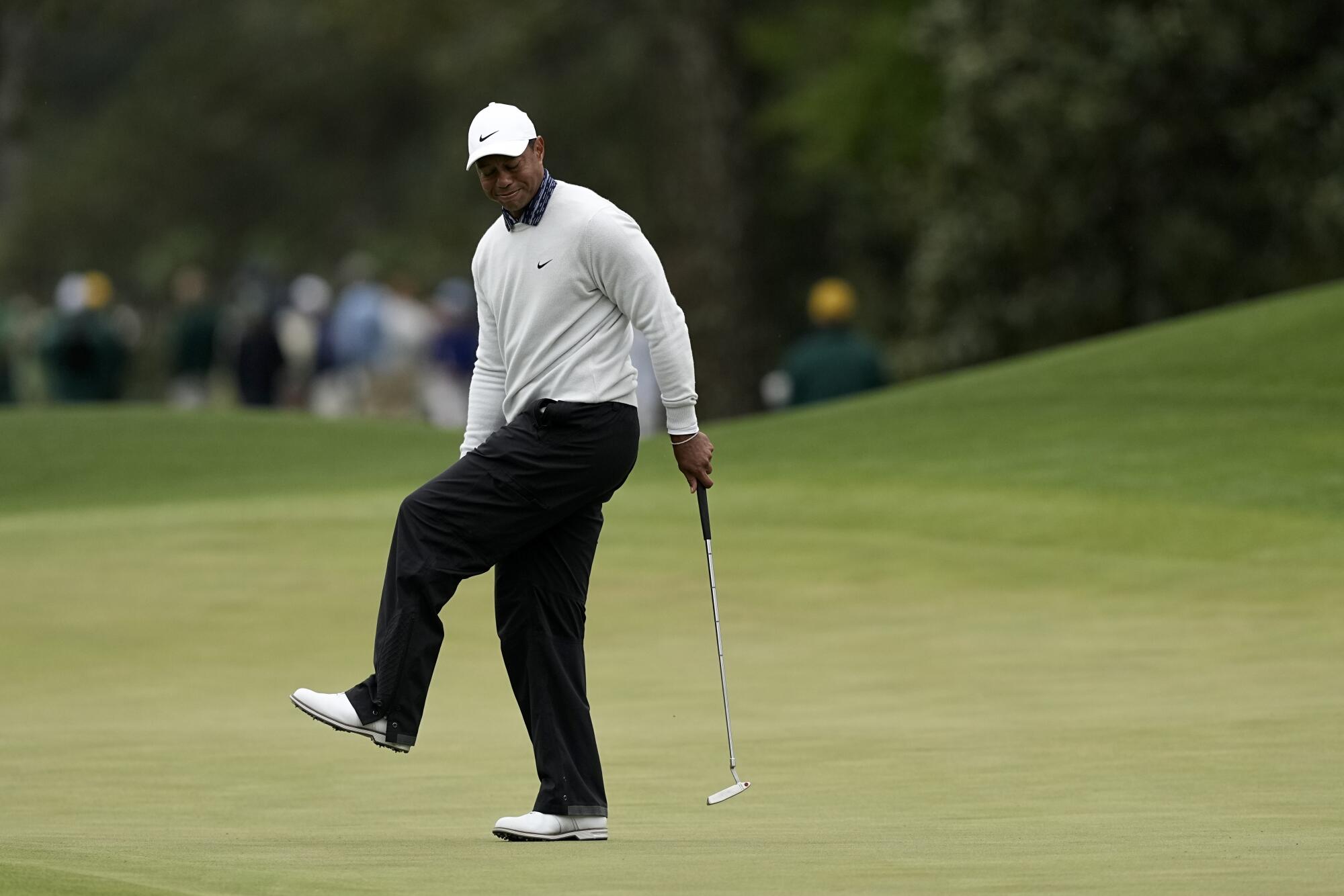 Tiger Woods reacts after missing a birdie putt on the eighth green during the third round.
