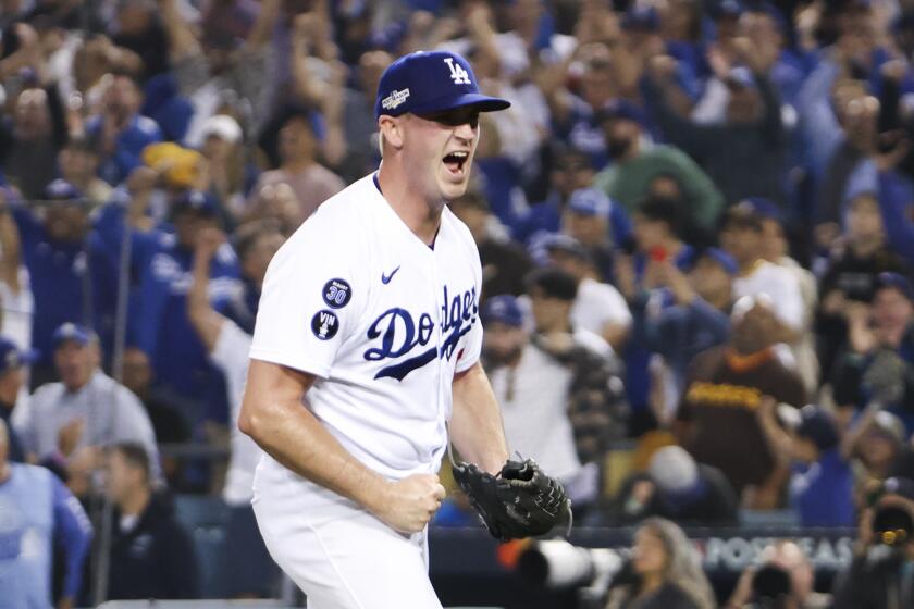 Dodgers relief pitcher Evan Phillips (59) reacts after San Diego Padres Wil Myers hits a ground ball into a double play 
