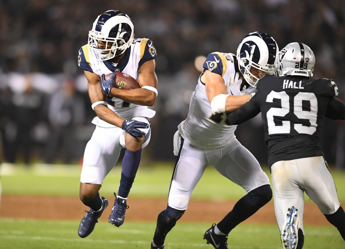 Los Angeles Rams receiver Robert Woods carries the ball against the Raiders in the 2nd quarter at the Oakland Coliseum Monday night.