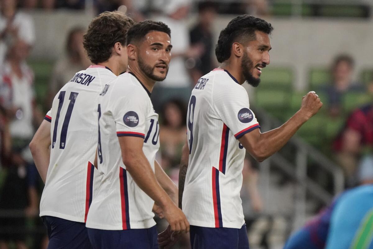 Jesus Ferreira, right, of the U.S. celebrates with teammates Cristian Roldan (10) and Brenden Aaronson (11) on June 10, 2022.