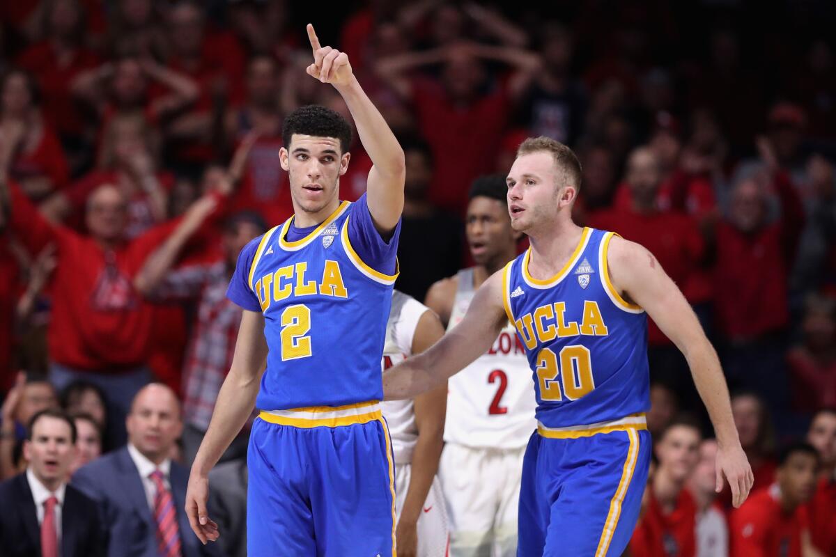 Bruins guards Lonzo Ball (2) and Bryce Alford (20) celebrate after forcing a turnover during the second half against Arizona on Saturday.