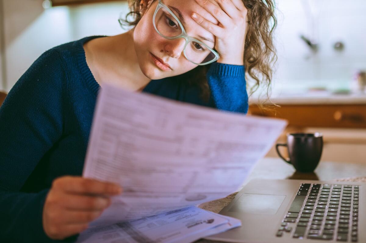  A woman looks over a billing statement