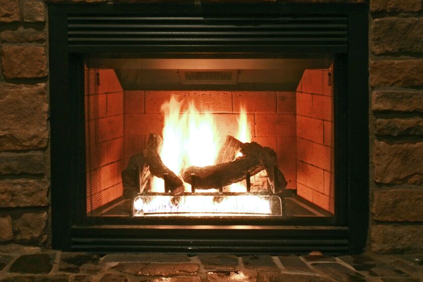 A fire burns in a gas fireplace.