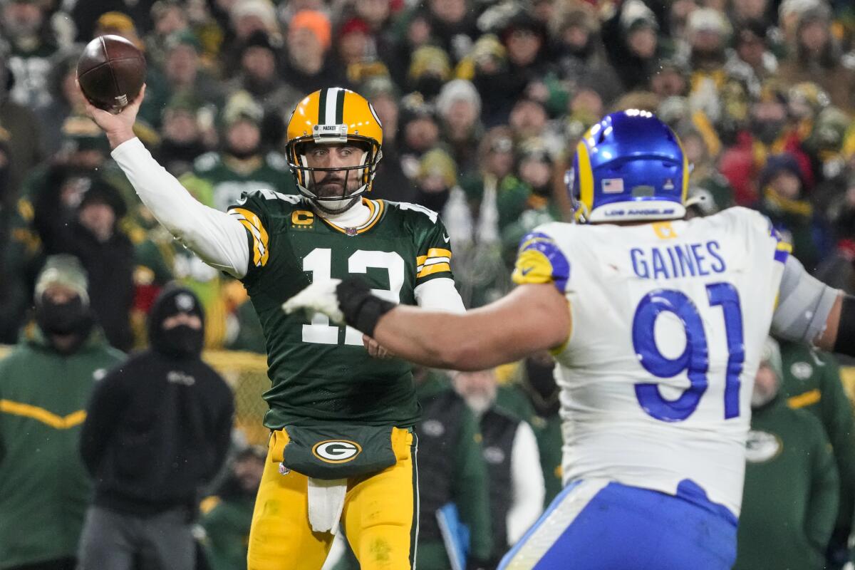 Green Bay Packers quarterback Aaron Rodgers passes in front of Rams defensive tackle Greg Gaines in the second half.